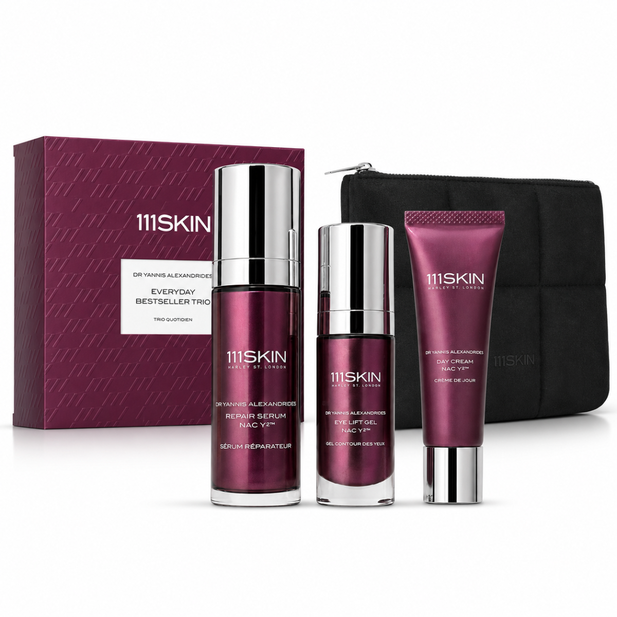 maroon skincare products in front of maroon box and black bag on white background